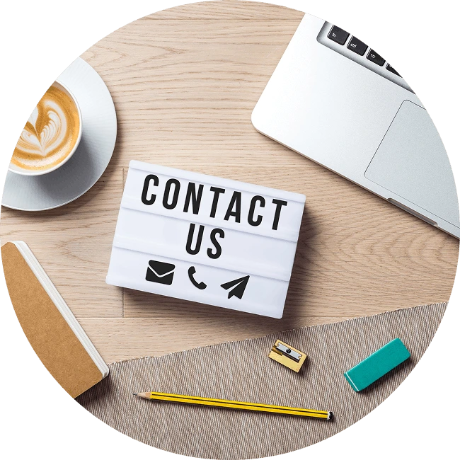 Contact us decorative image featuring a desk with a laptop, coffee and other random equipment.